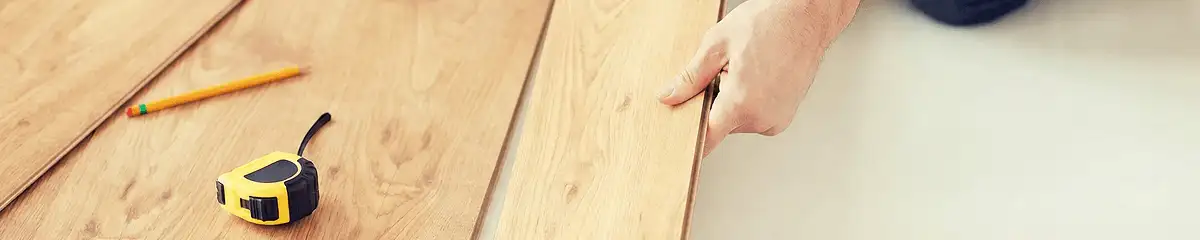 A professional installing wood flooring in Austin, TX
