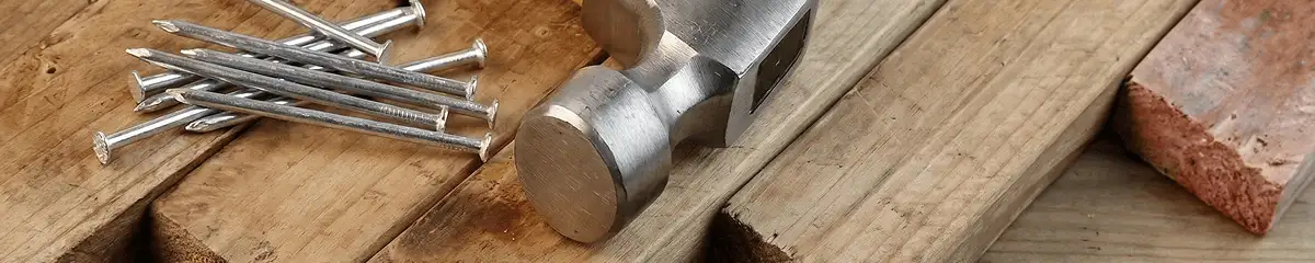 Hammer and nails on hardwood flooring boards in Austin, TX
