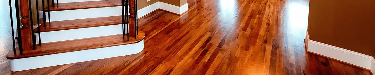 Base floor of a staircase with professionally restored wood flooring in Austin TX