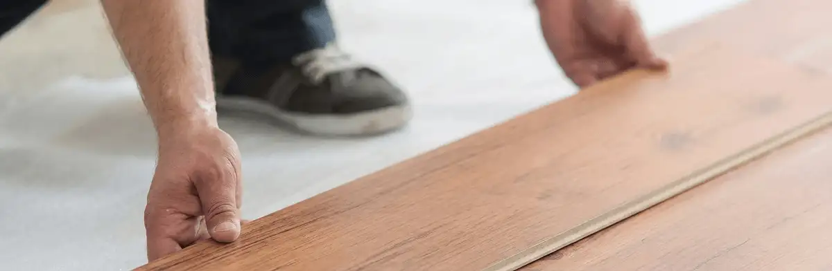 A professional installing laminate flooring in Austin, TX
