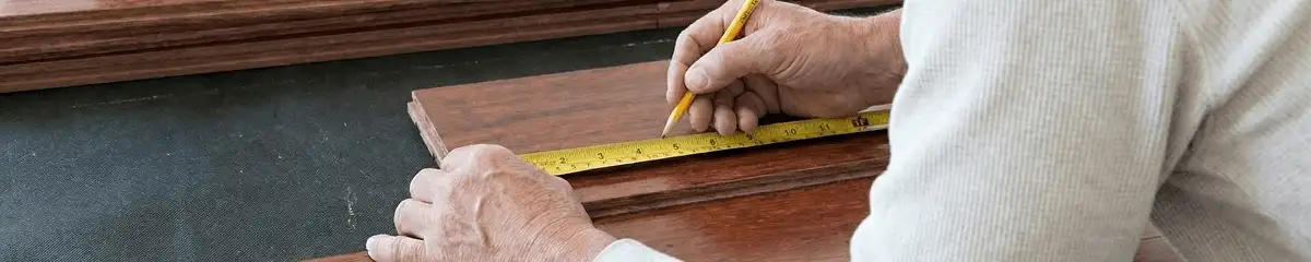 A professional installing wood flooring in Austin, TX